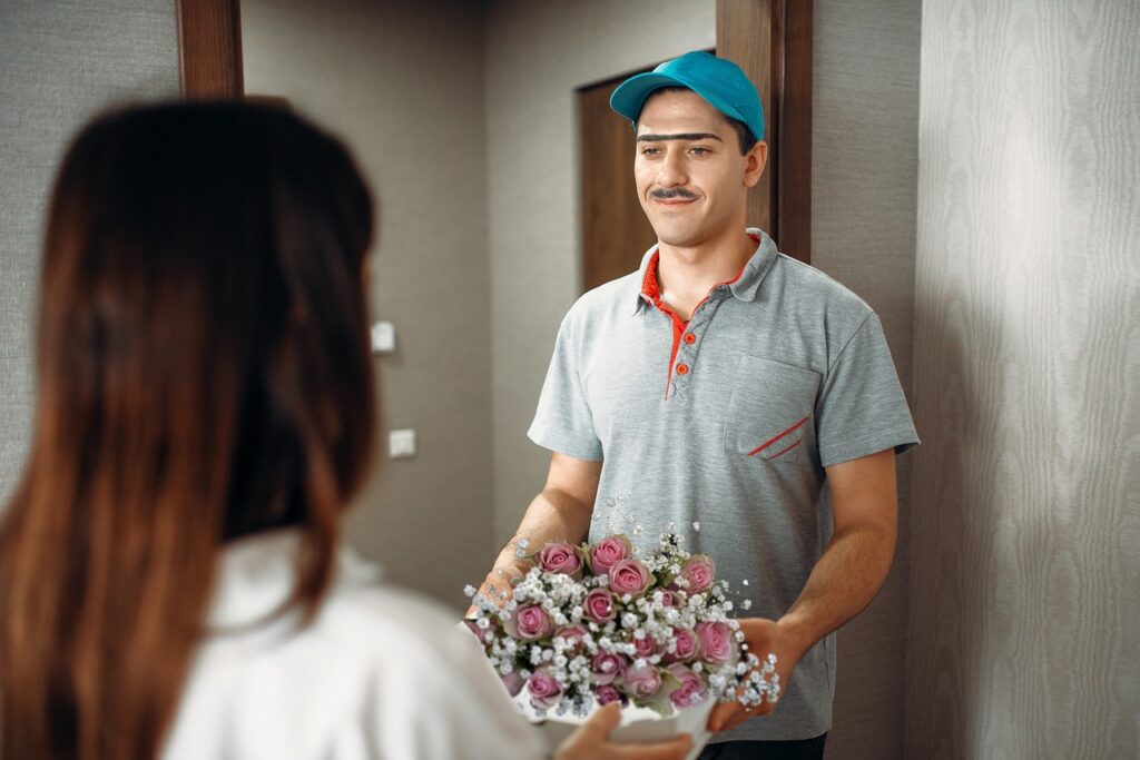Delivery guy giving flower bouquet