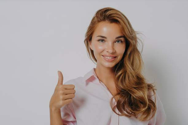Girl with glowing skin showing thumbs up