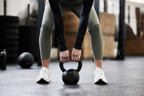 Shot of a woman working out with a kettle bell I'm here to workout gym stock pictures, royalty-free photos & images