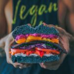 Man in vegan t shirt with vegan burger
