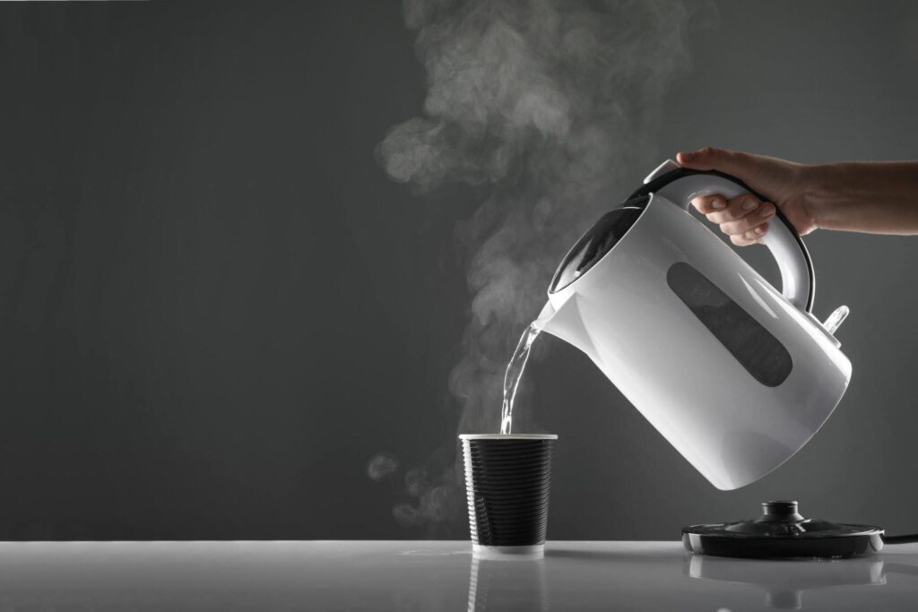 kettle pouring hot water in mug