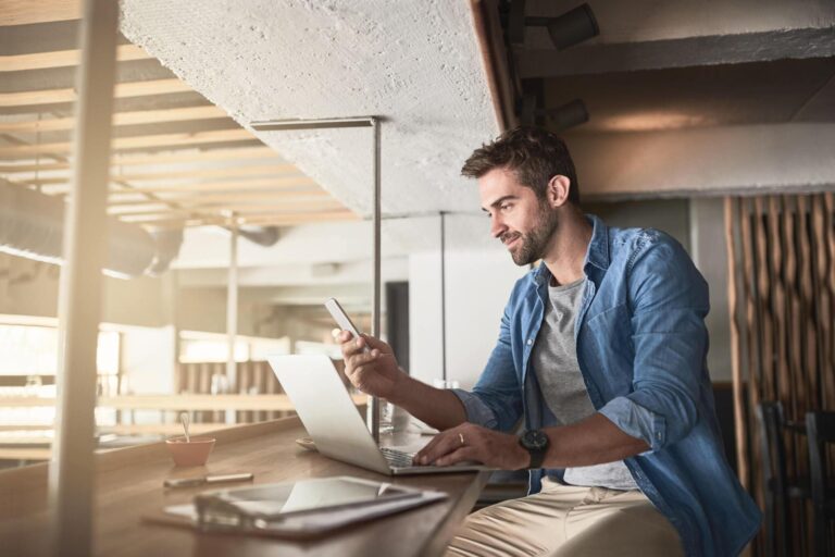 Man using mobile and laptop