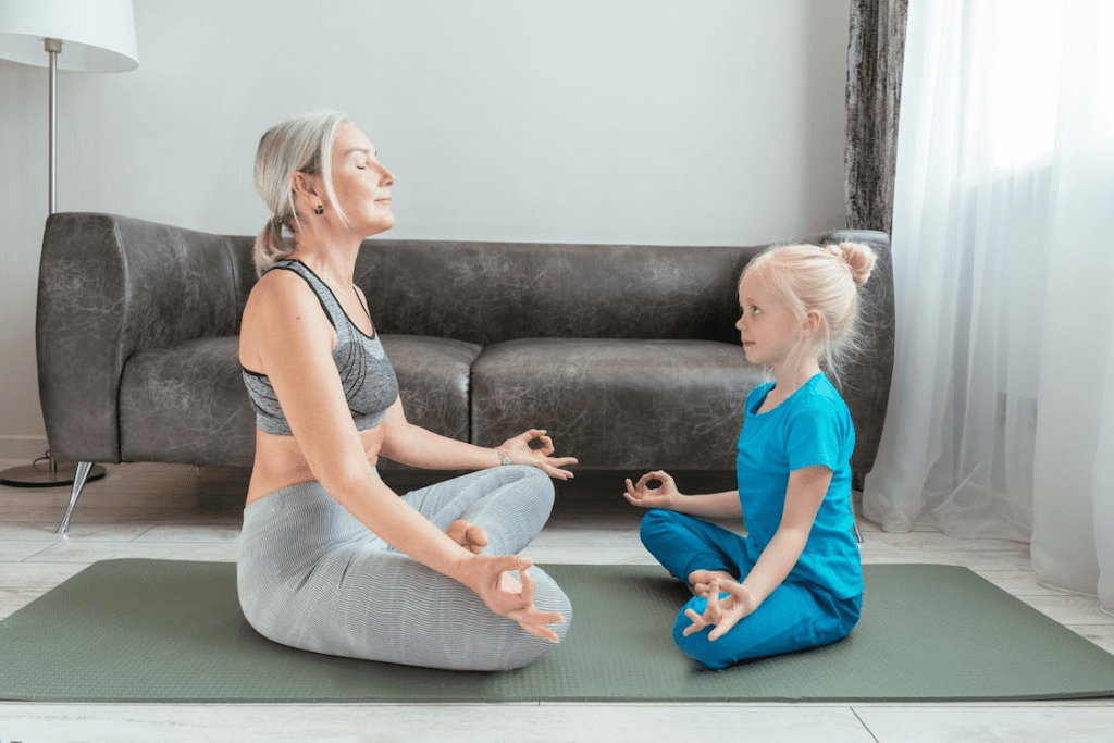 mother and daughter doing yoga together
