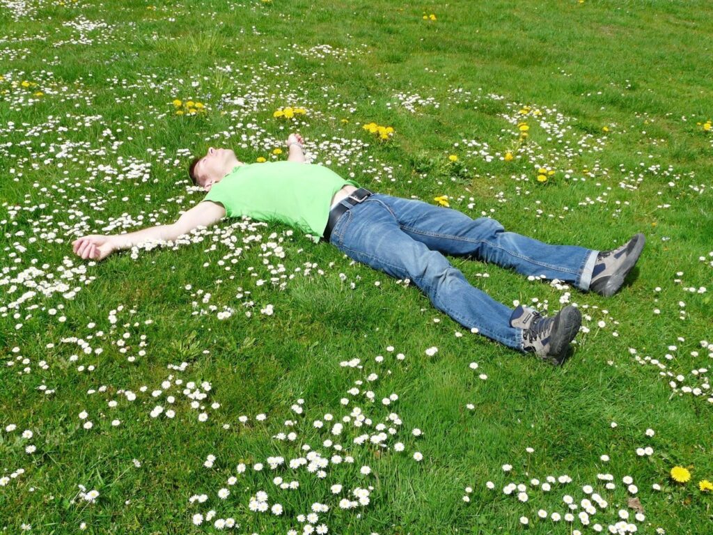 Man having a healthy sleep on the green field