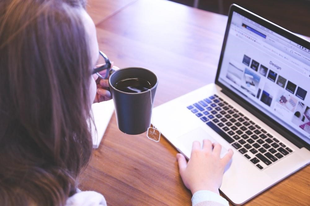 woman drinking black with while working