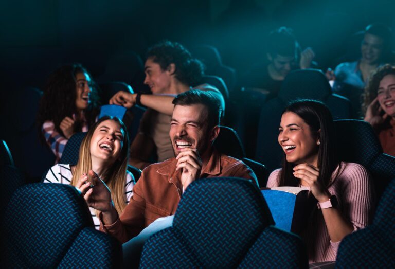 group of friends watching movie in a theatre