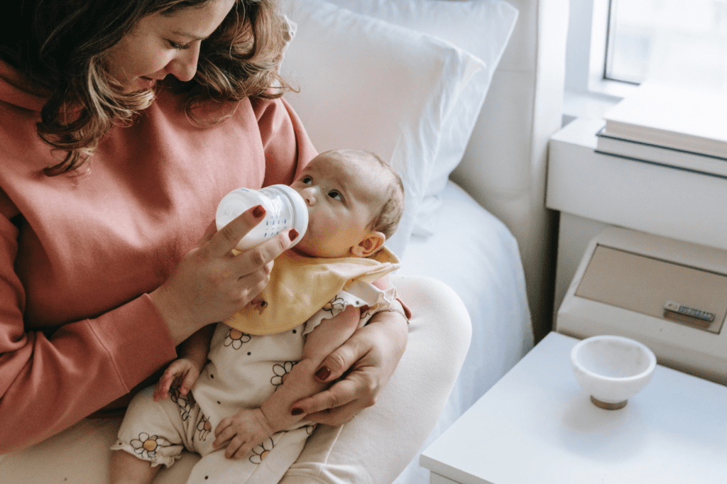 mom feeding Infant Formula to her child