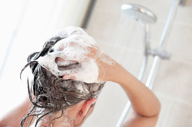 Woman washing hair with organic shampoos